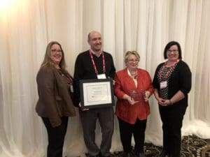 Jason Van Rooy and Alicia Koskey, Property Manager receive the award for Outstanding Community Service