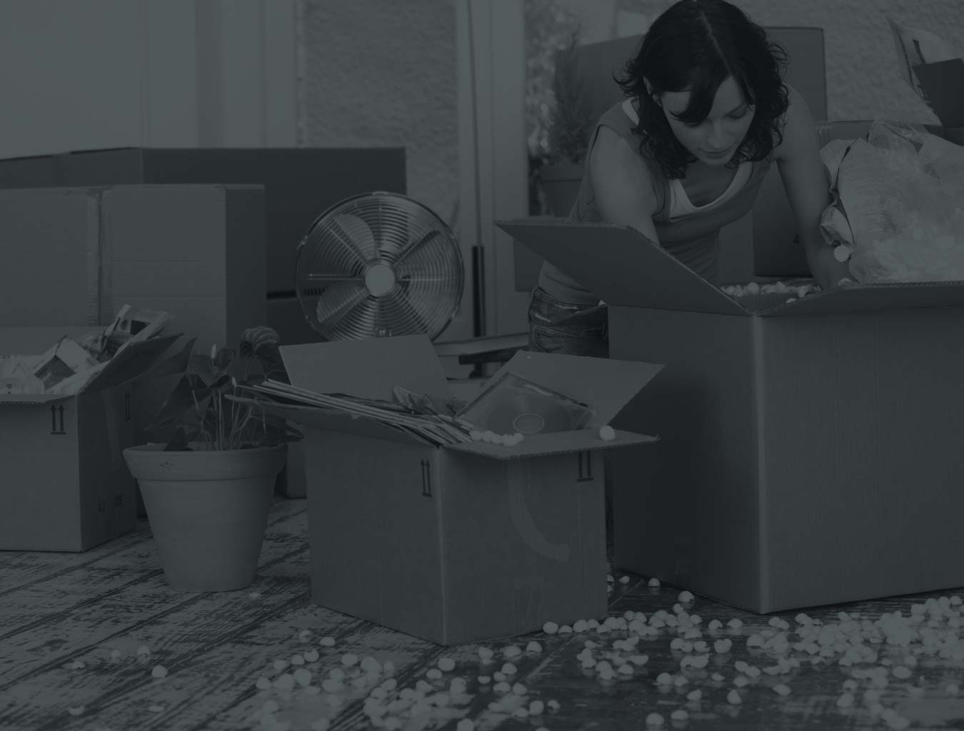 black and white image of woman unpacking
